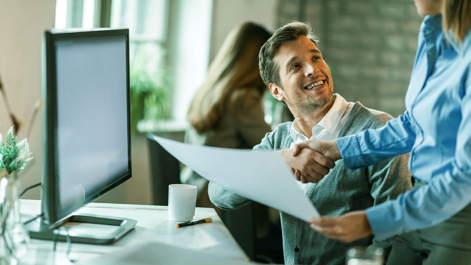 Team members collaborating on a project in a modern office setting