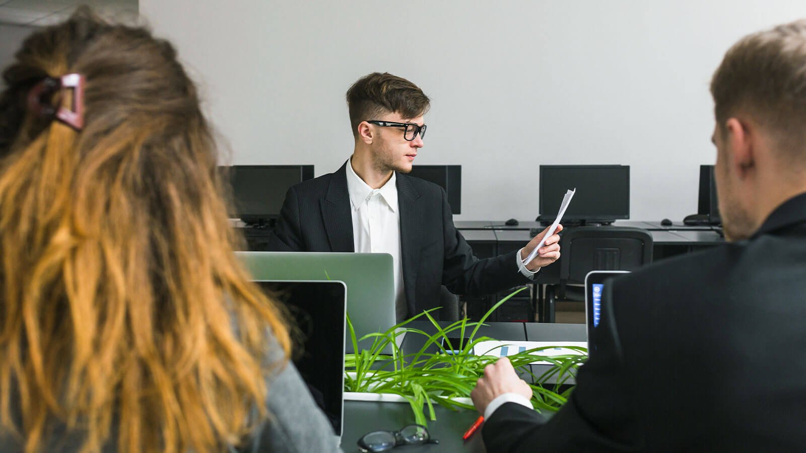 Team members collaborating on a project in a modern office setting